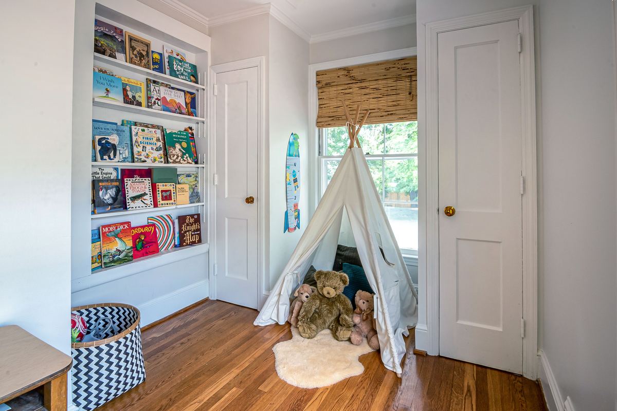 A children's room with a play tent and soft toys