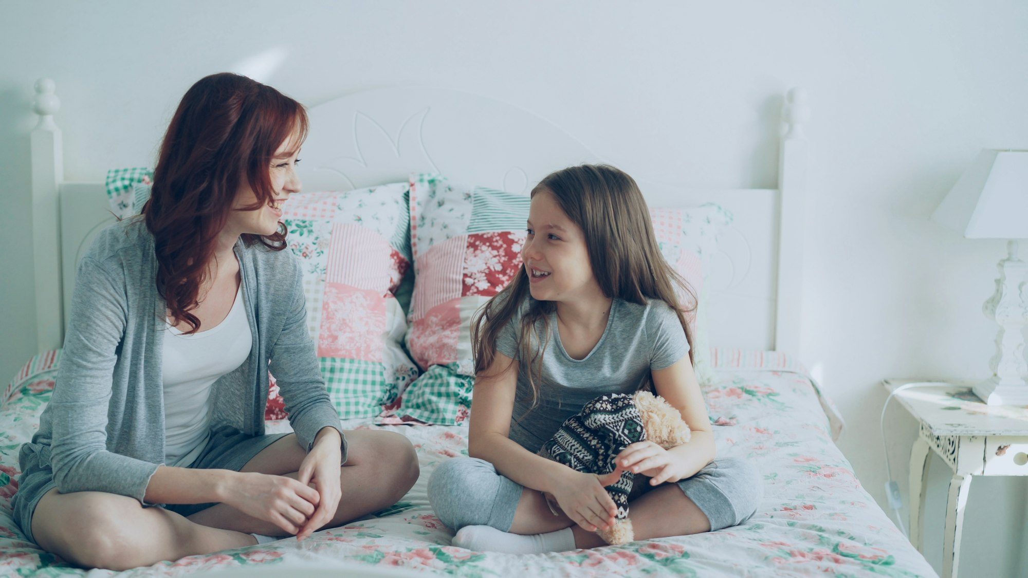 A parent and child sitting together and talking calmly at home