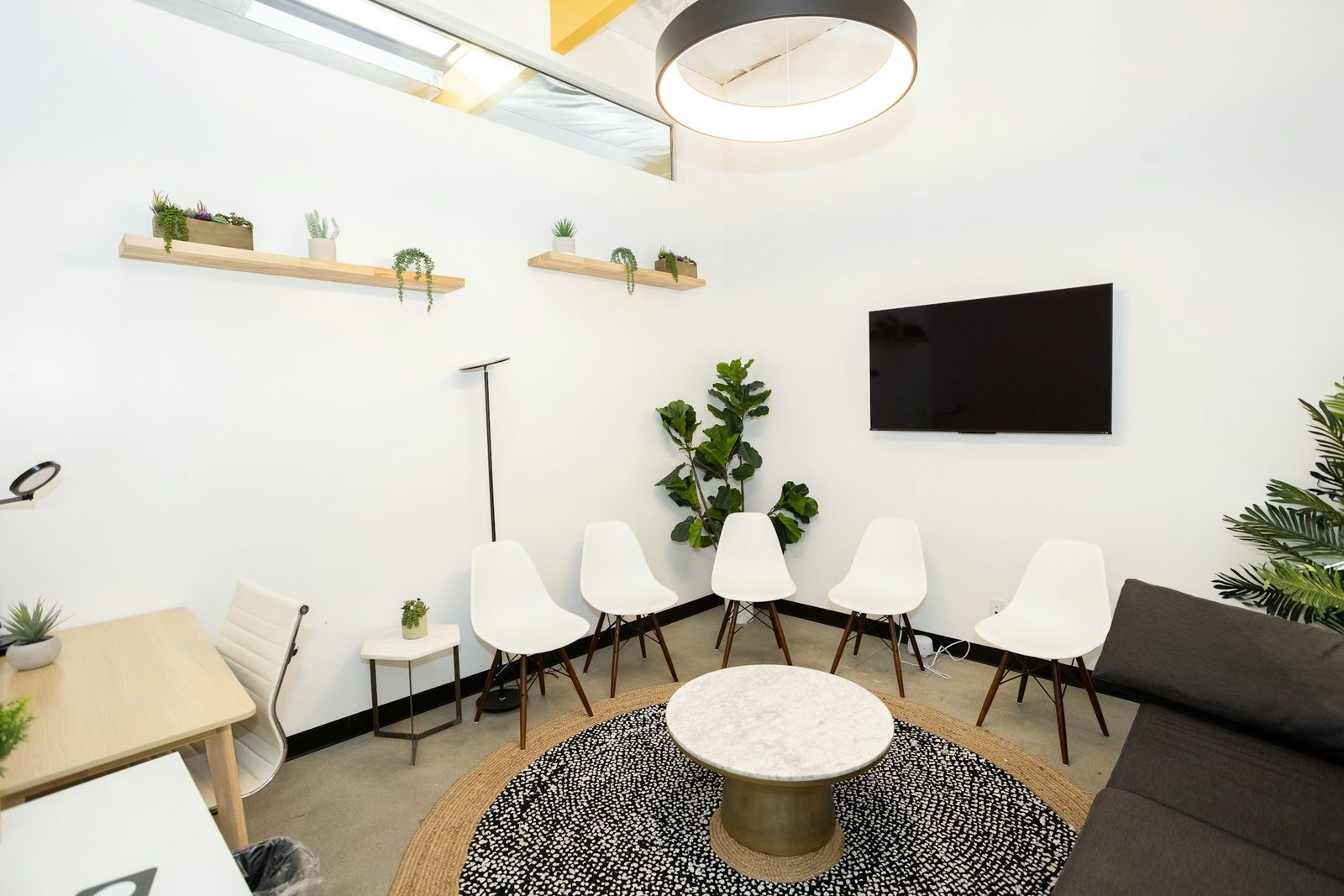 A comfortable therapy room with two chairs beside a window