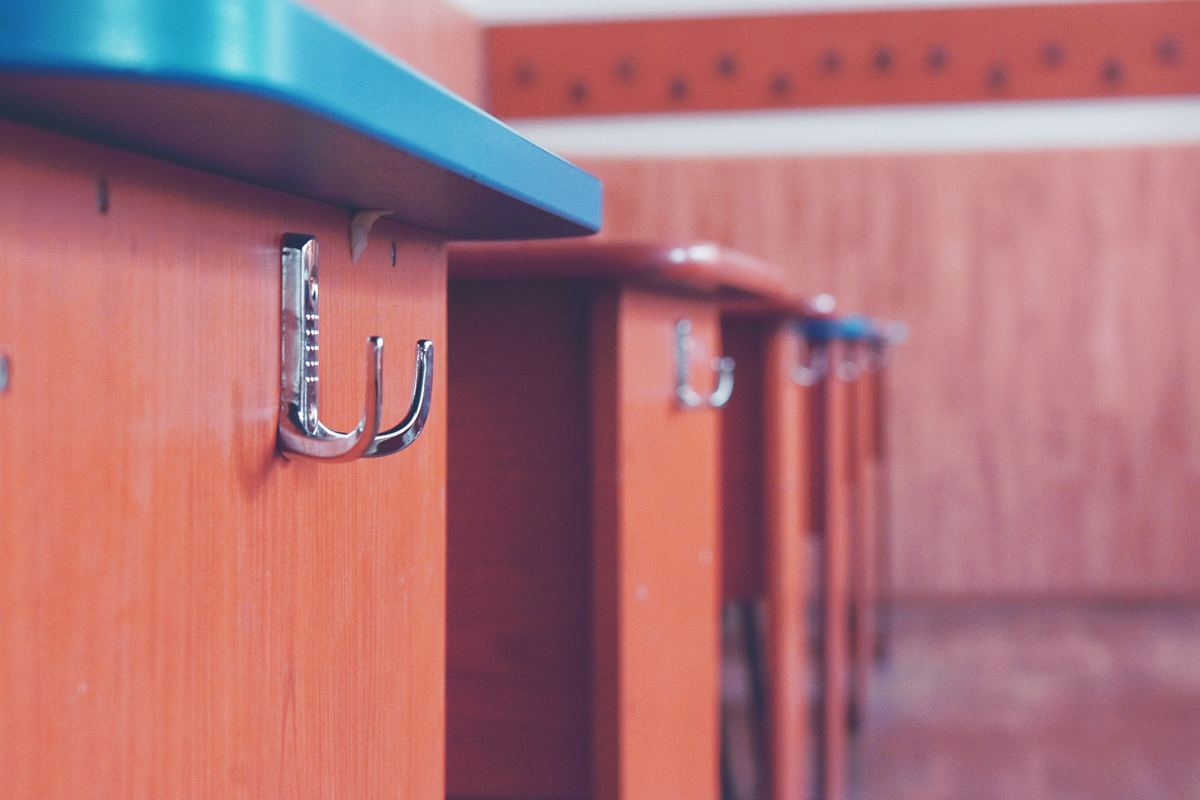 A close-up of a hook on classroom furniture