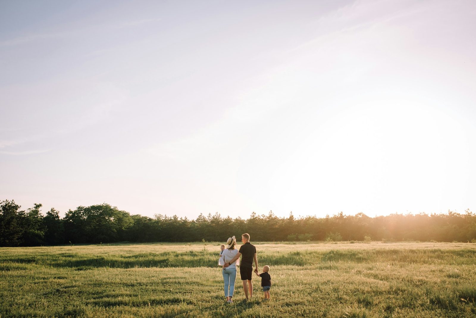 A family walking together outdoors on a warm afternoon