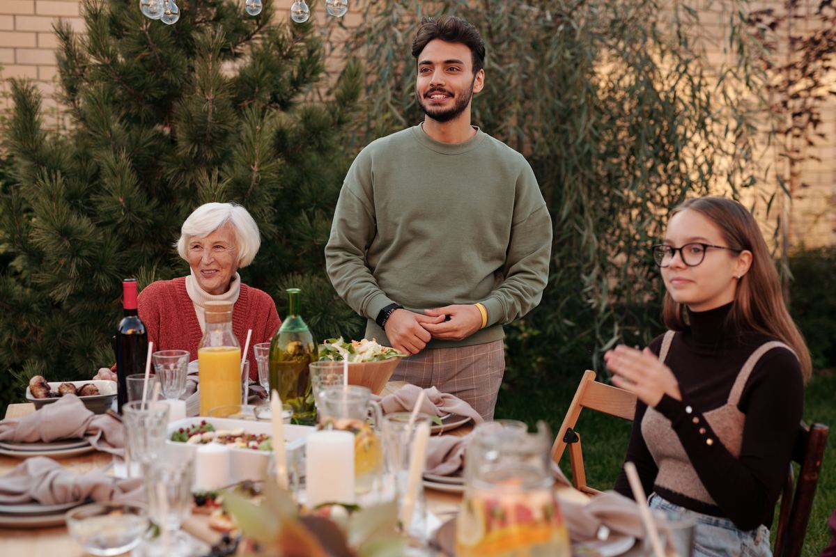 Family members sharing a meal at an outdoor table