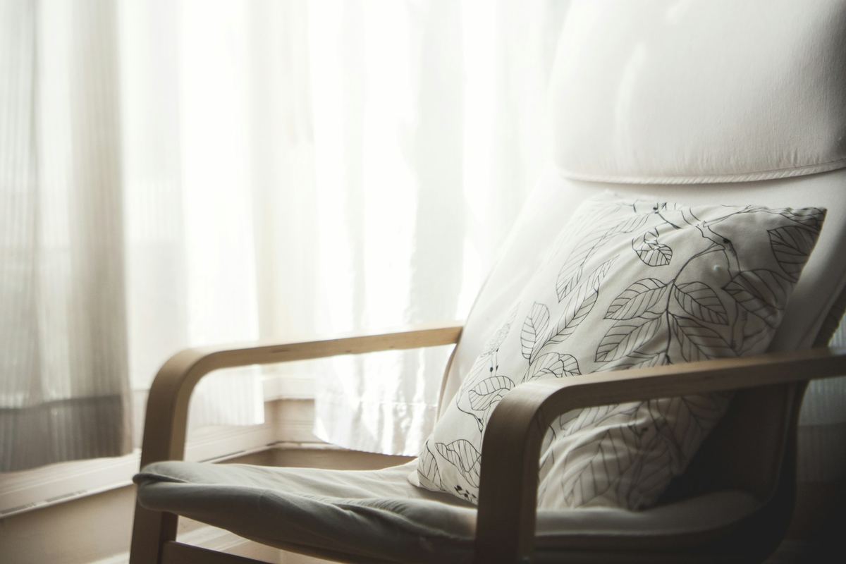 An armchair beside a window in soft daylight