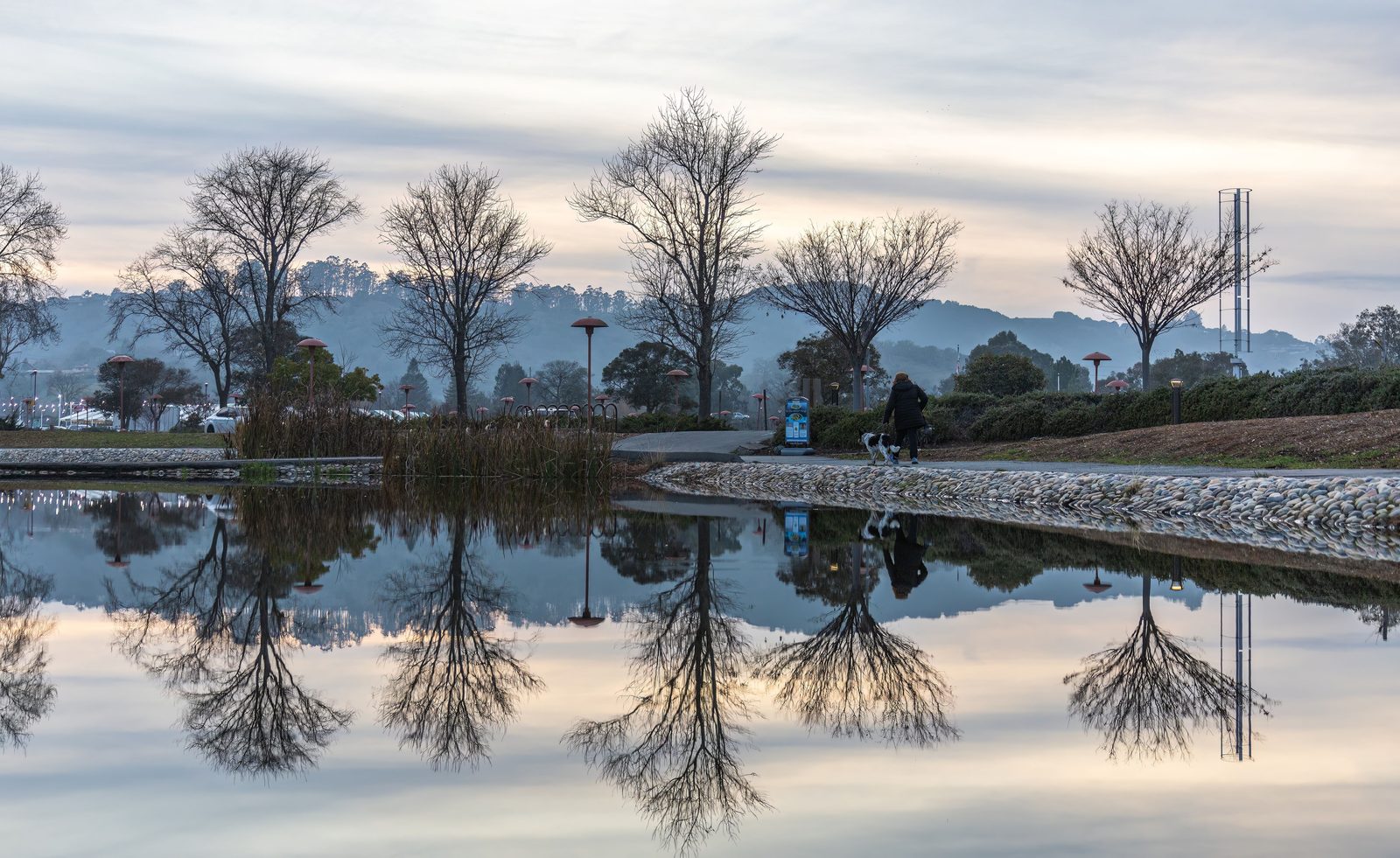 A person walking a quiet path at sunrise
