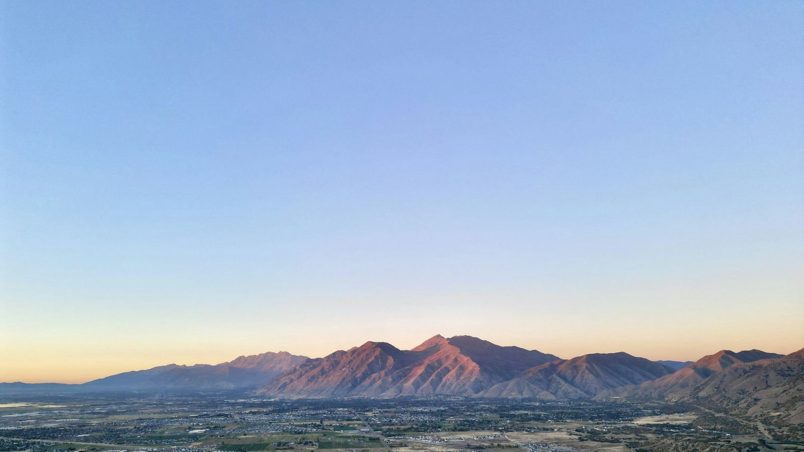 Utah Valley at dusk with the Wasatch mountains beyond the city