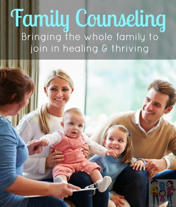 A family with two young children sitting together with a counsellor