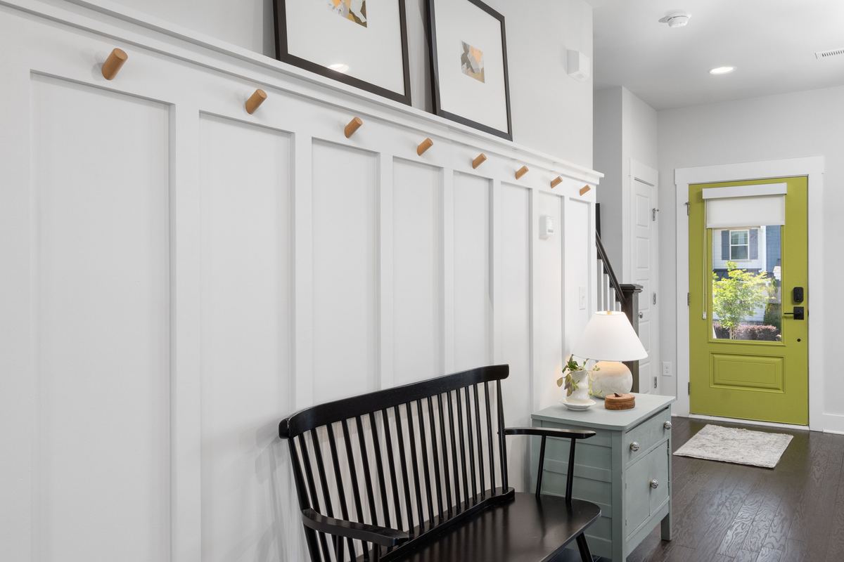 A home entryway with a bench and a green front door