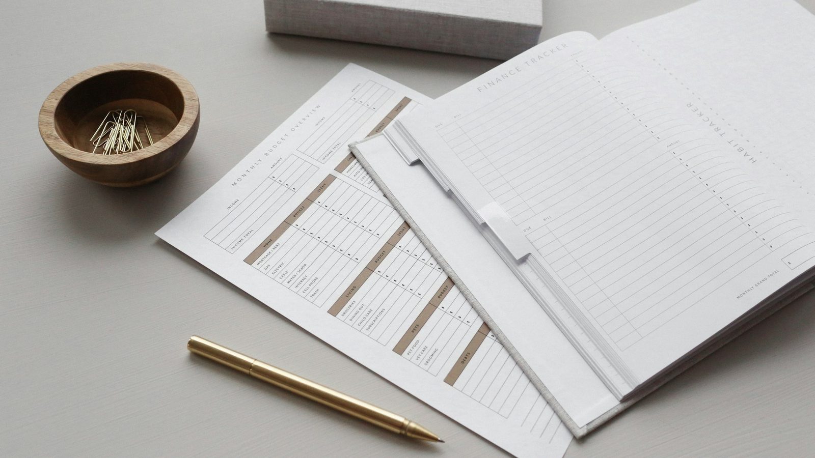 A clipboard holding a blank form beside a pen on a desk
