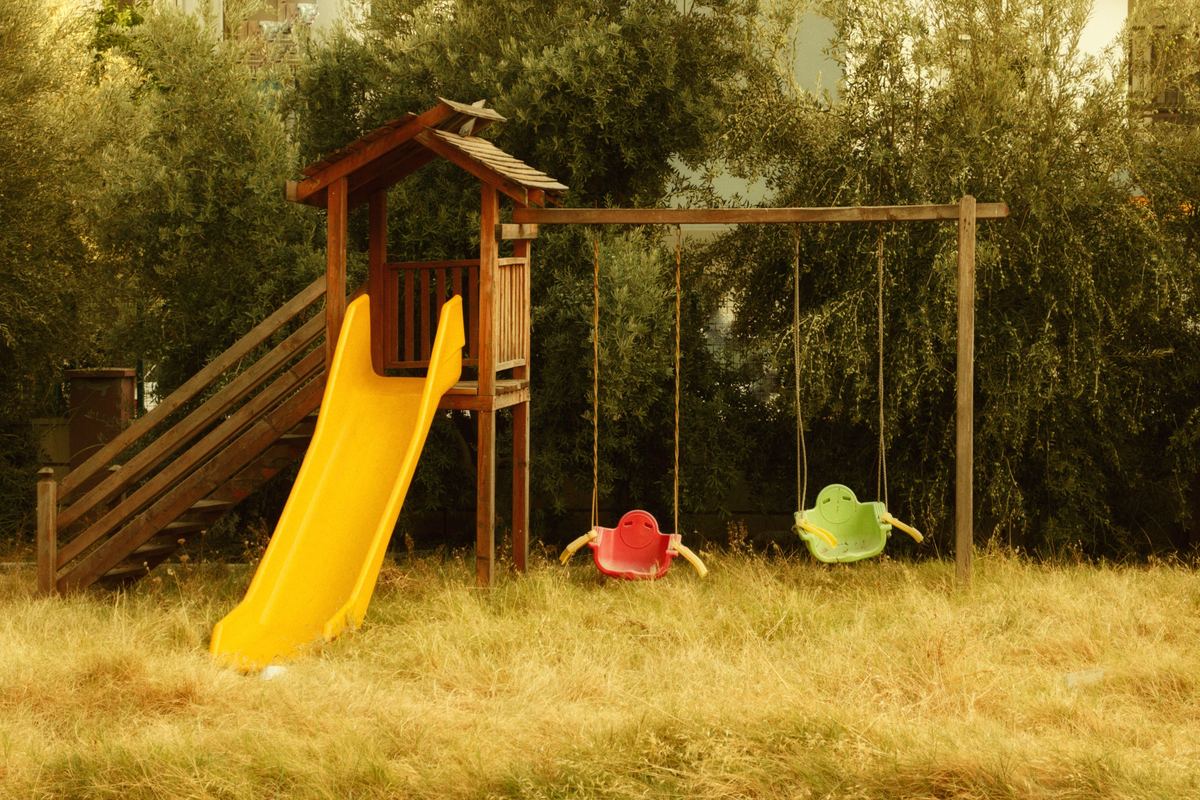 A quiet playground with a slide and swings