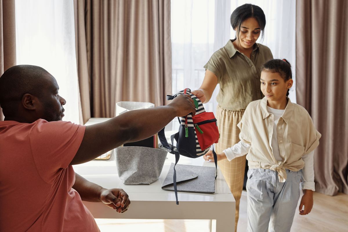 A parent helping a child pack a bag
