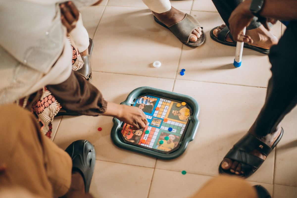 Children playing a board game together on the floor