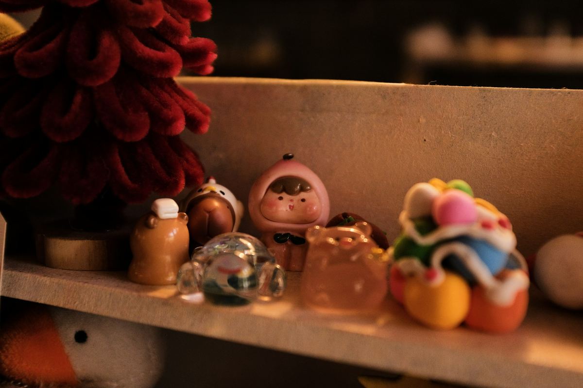 A collection of small decorative figurines arranged on a shelf