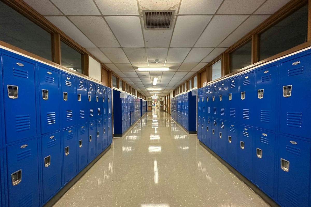 An empty school hallway lined with lockers