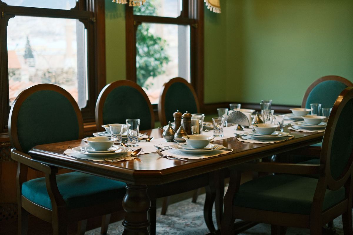 A dining table set with places for a family meal