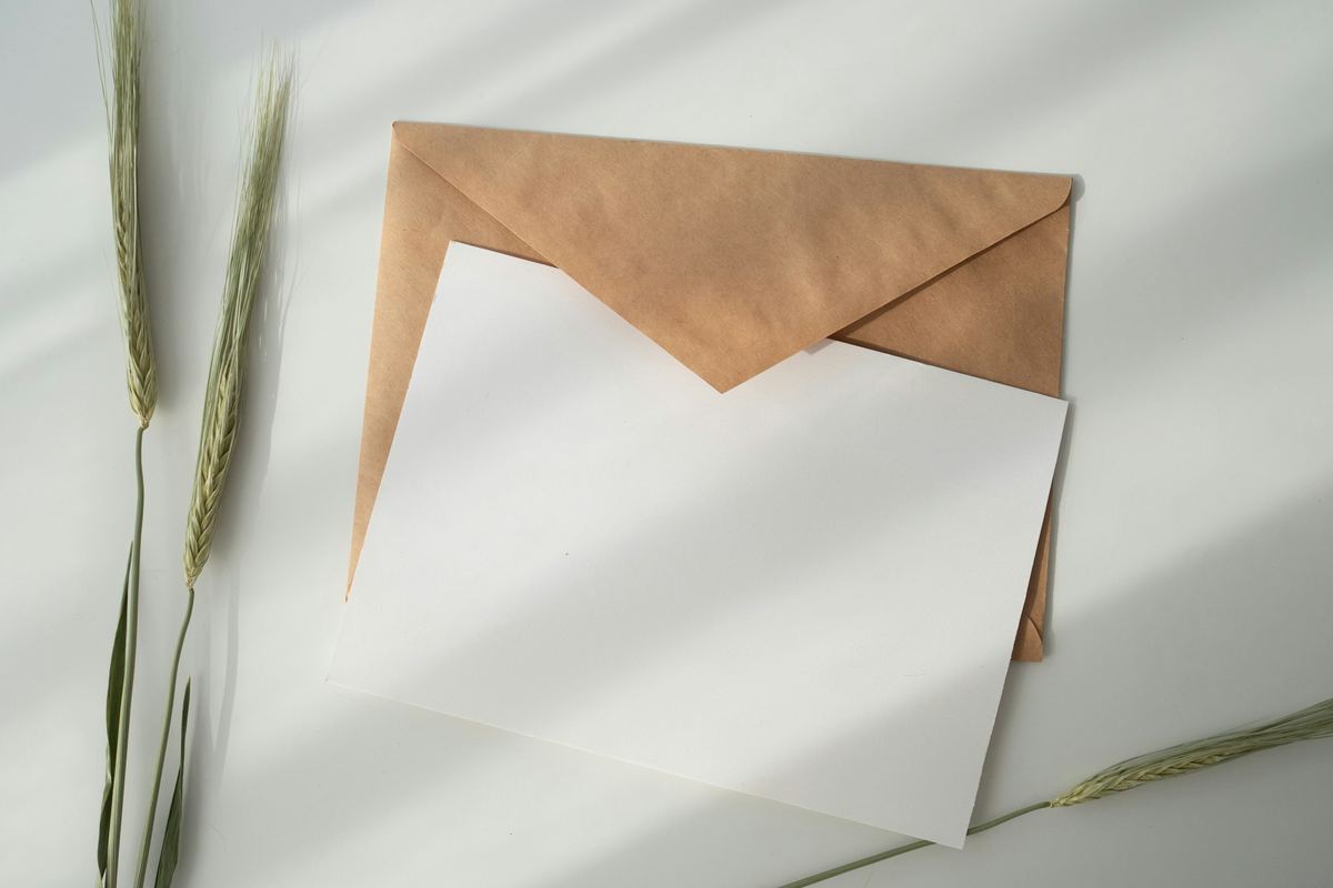 A sheet of paper beside a brown envelope