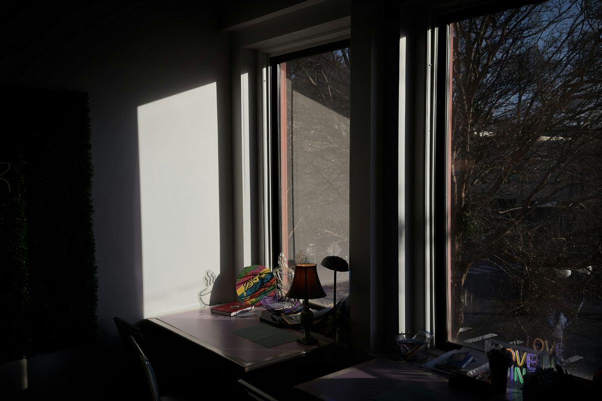 Sunlight falling across a desk beside a window