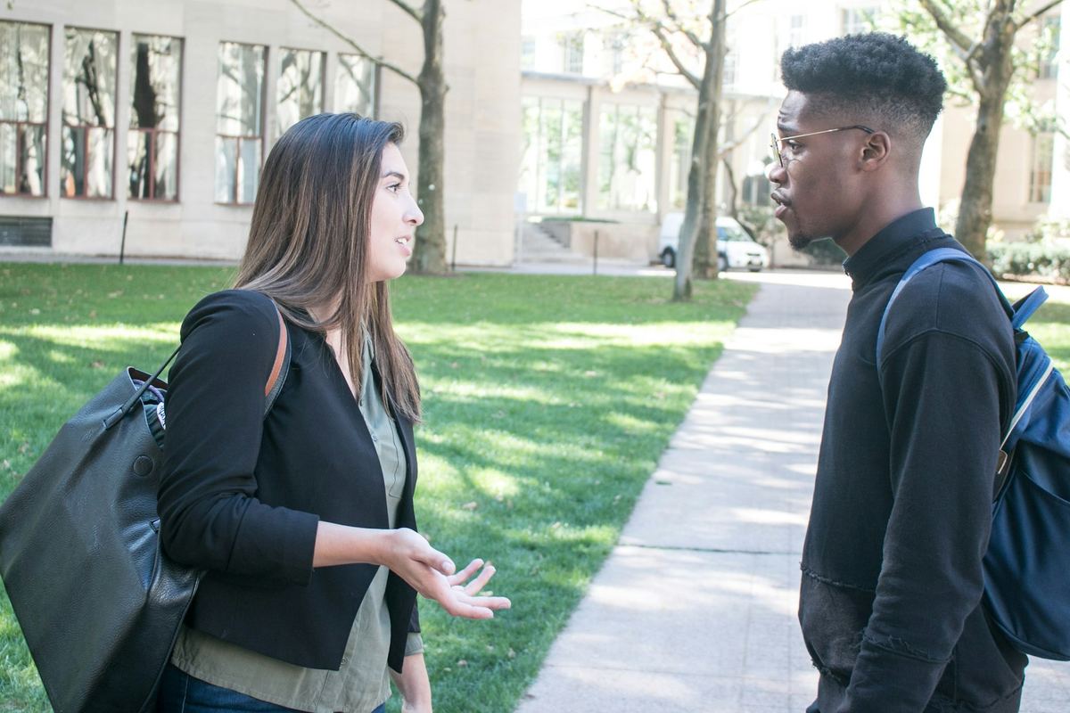 Two people standing outdoors in conversation