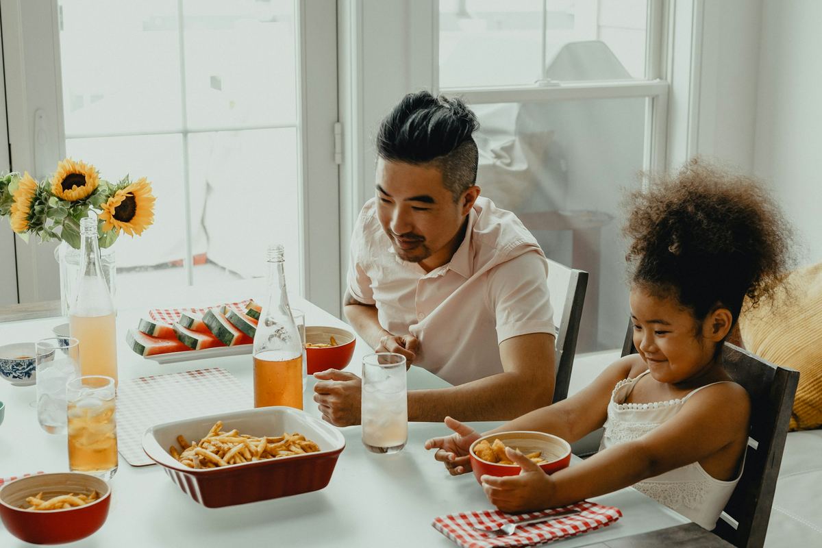 A family sitting around a table together at a meal
