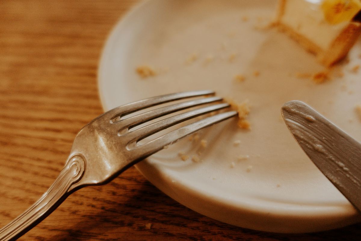 A fork and knife resting on a finished plate