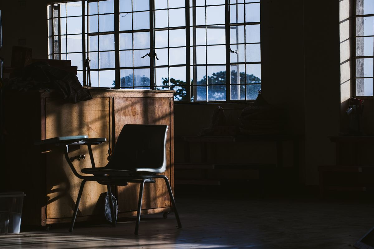 A quiet room with natural light falling across a chair