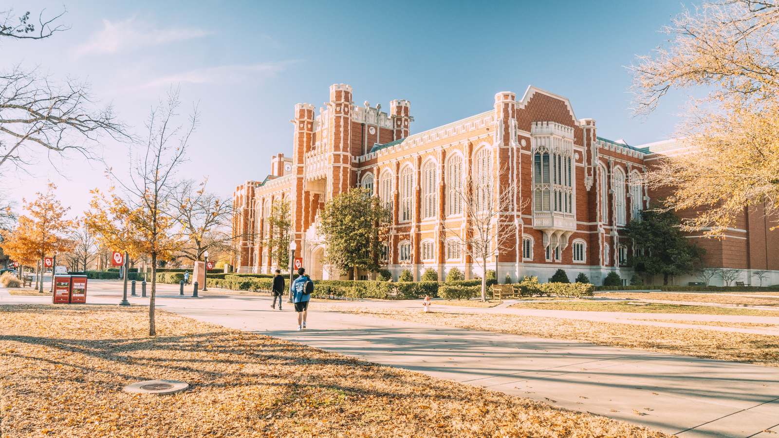 A historic university building surrounded by autumn trees
