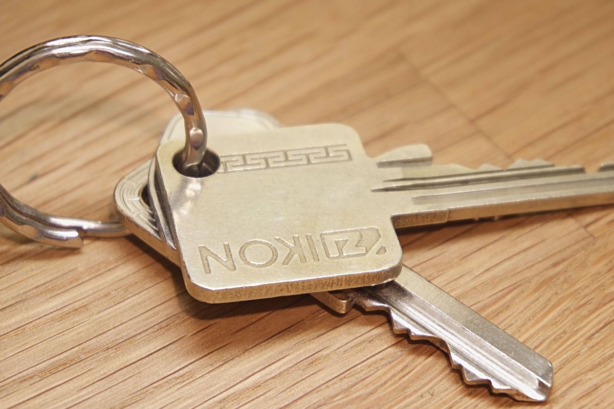A set of house keys resting on a wooden surface