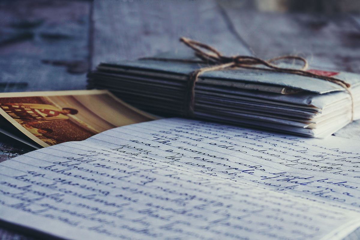 A bundle of old letters and photographs tied with string