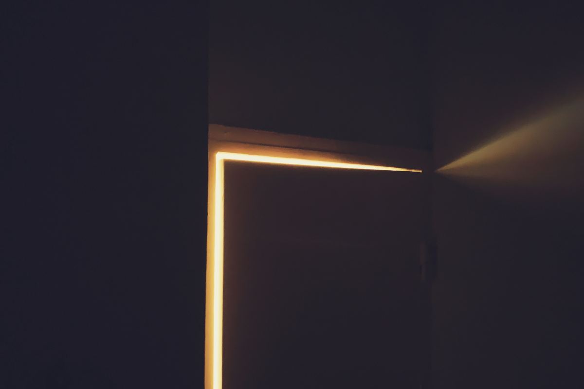 A beam of warm light coming through a partly open doorway
