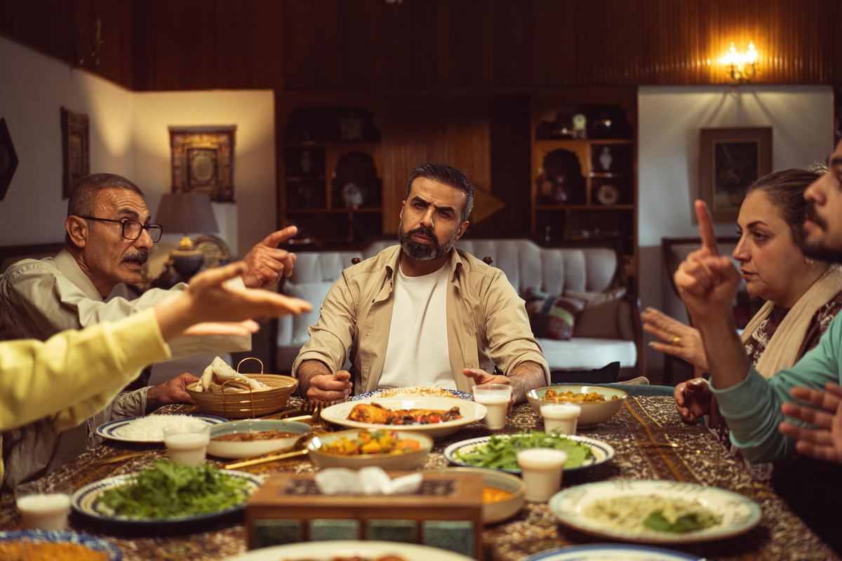 A family talking animatedly around a dinner table