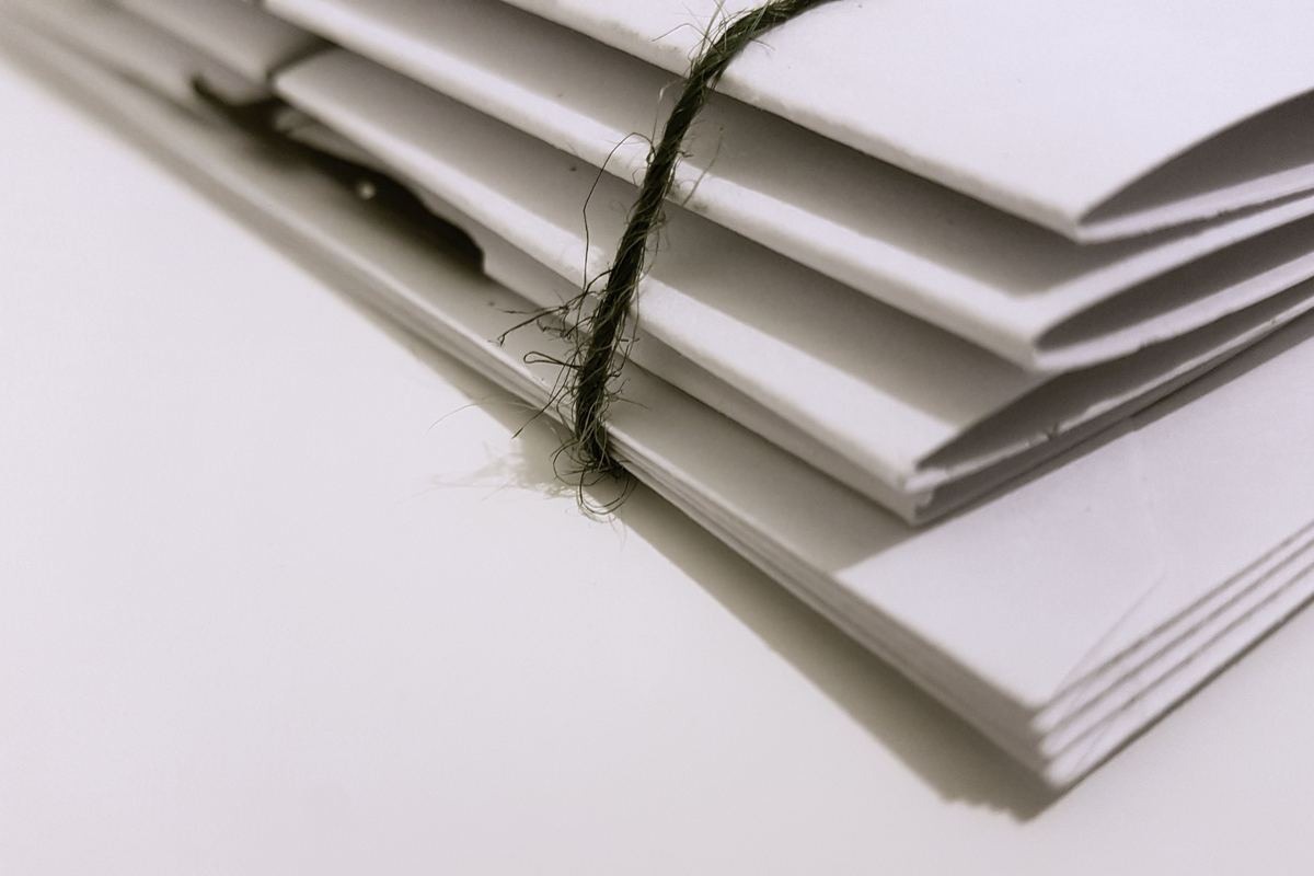 A pile of unopened envelopes tied with string