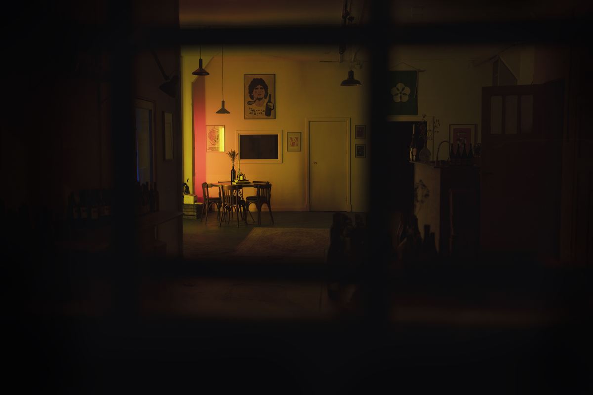 A dimly lit dining room seen through a doorway