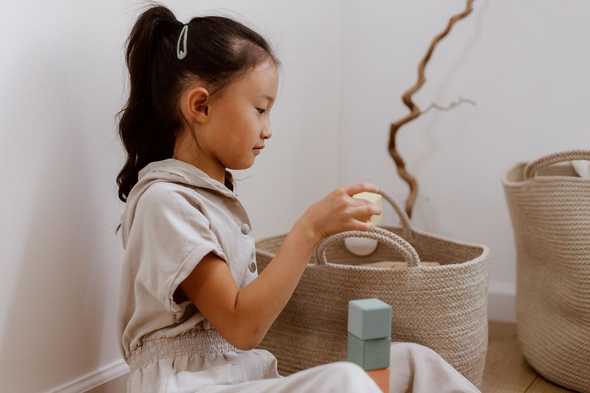 A child putting toys into a basket